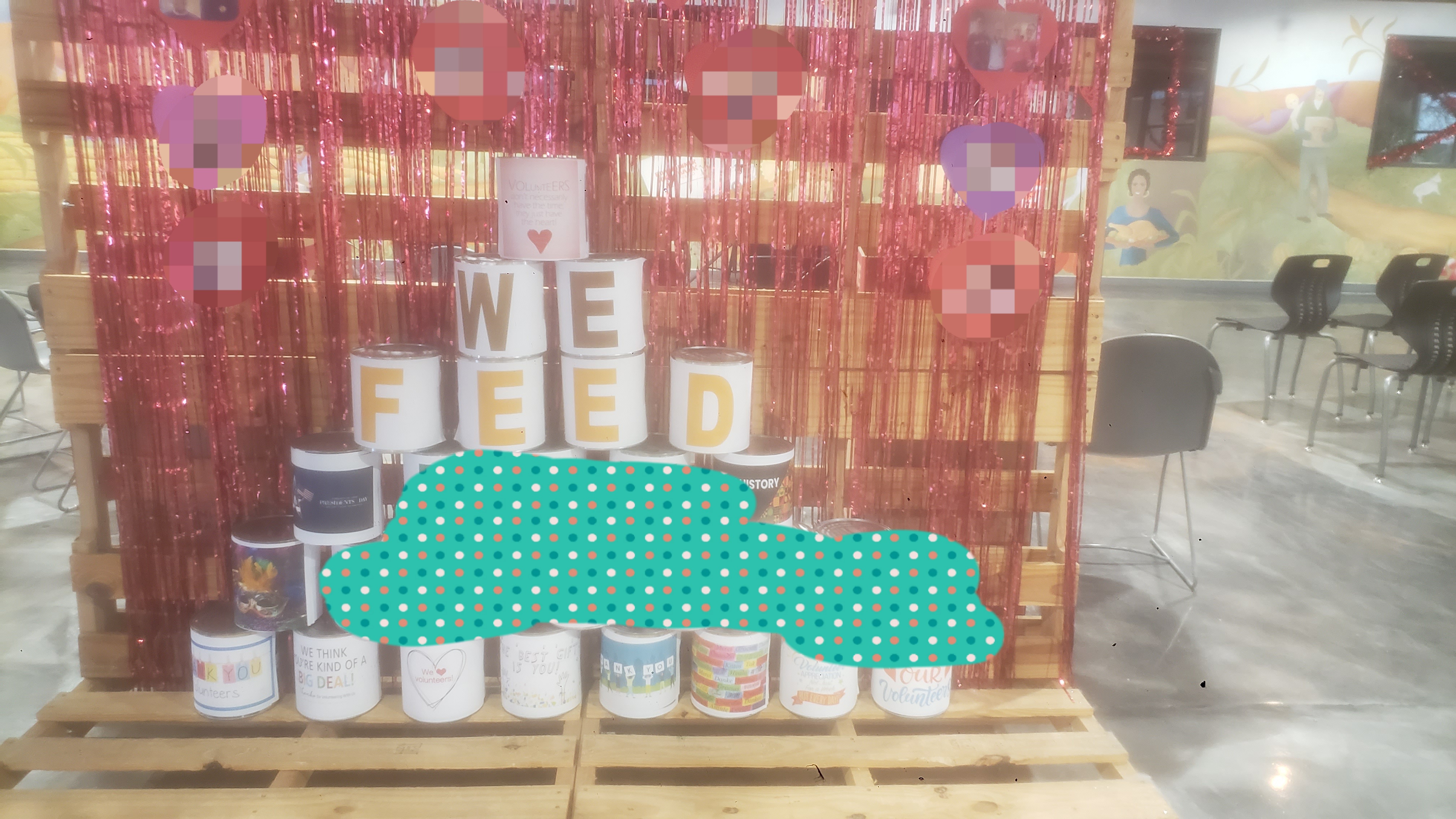 Valentines day pallet display with a stack of big food cans that said we feed the state and thank plus love the volunteers.